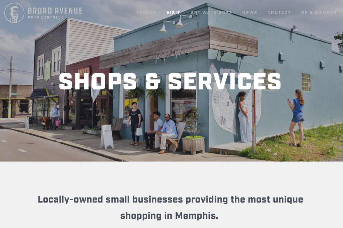 This image showcases a row of colorful storefronts, an artistic mural, and people interacting along a lively street. The vibrancy and street art visually echo the creative energy of the Broad Avenue Arts District, highlighting its eclectic mix of local businesses and public art.
